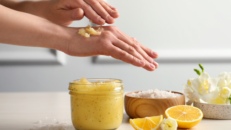 Woman applying a body scrub