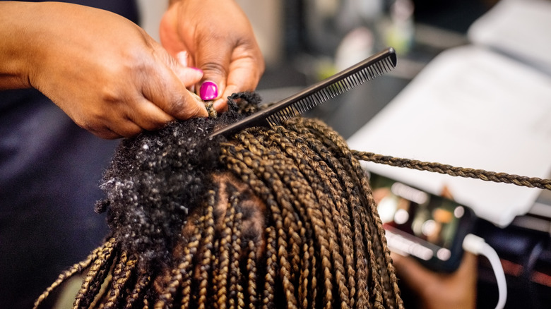 woman braiding and parting hair