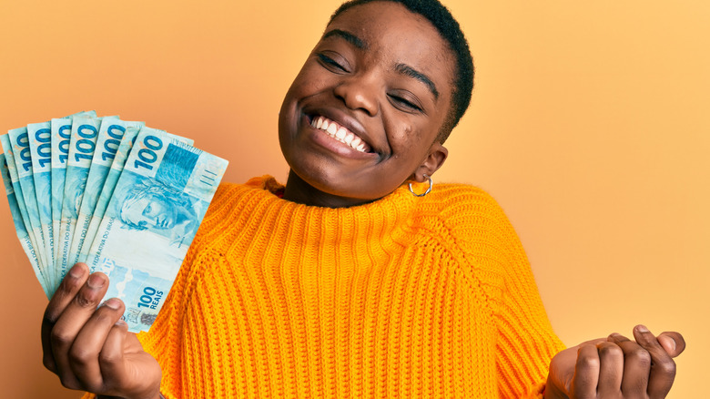 female smiling at cash