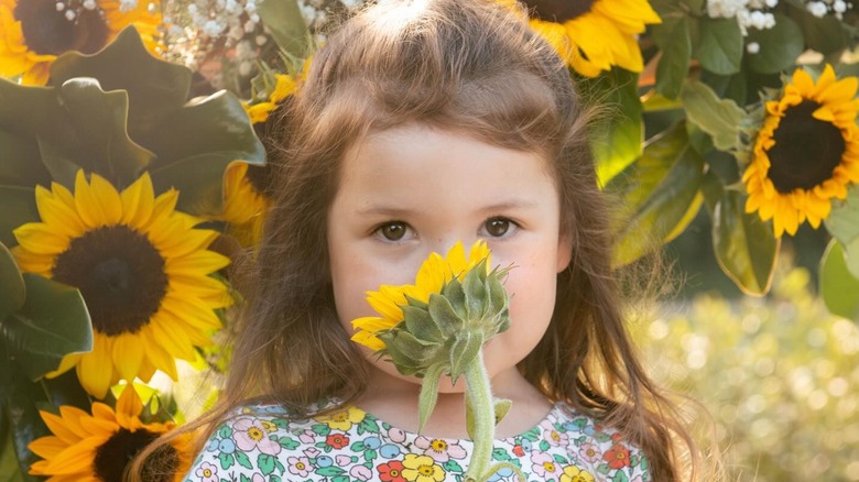 Bindi Irwin's daughter Grace Irwin holds a sunflower