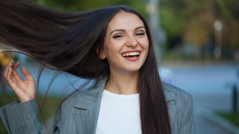 smiling woman flipping hair