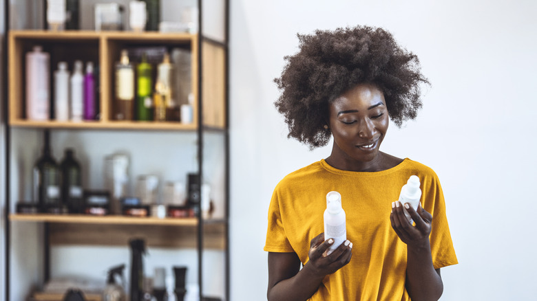 woman holding hair and product