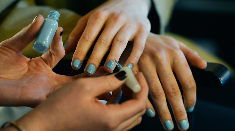 woman getting nails painted