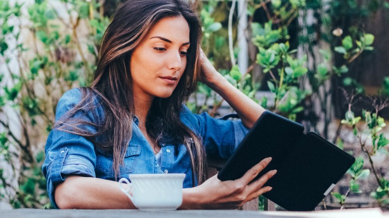 Woman reading e-book outside