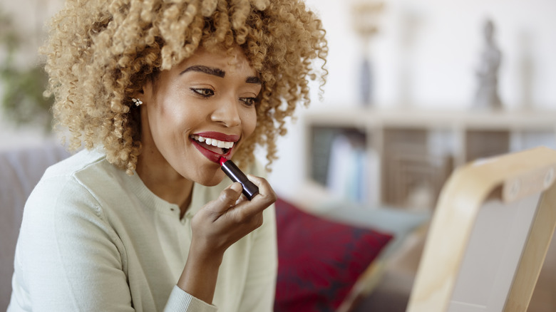 Girl applying lipstick