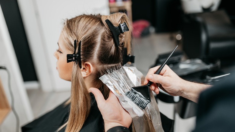 woman getting hair dyed