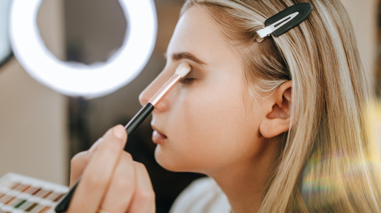 makeup artist applying eyeshadow