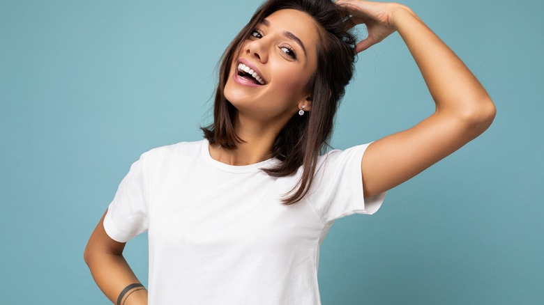 Smiling woman in white shirt