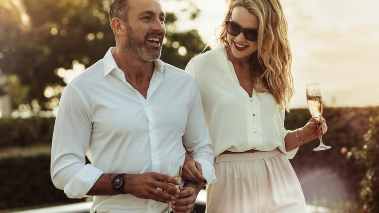 smiling couple wearing white clothes