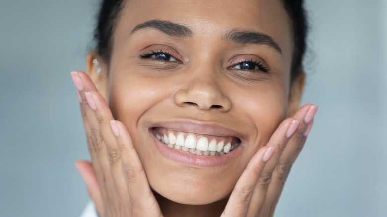 Woman using extraction tool during facial 