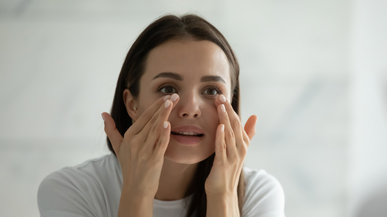 woman applying eye cream