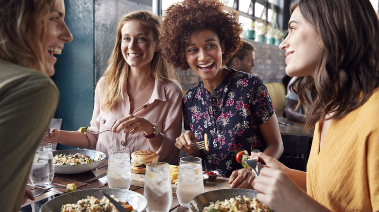 happy women dining at restaurant