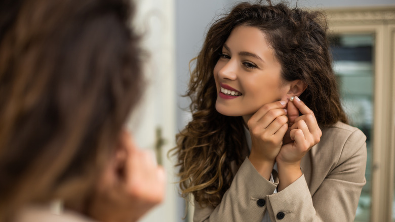 Woman tries on earrings