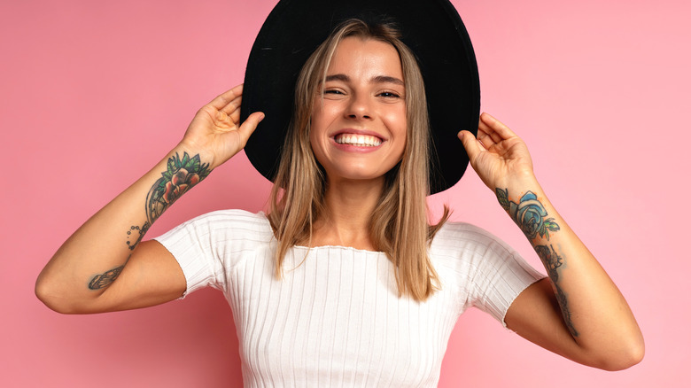 Smiling woman with arm tattoos