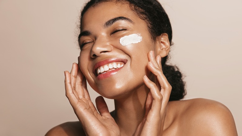 woman with cream on cheek