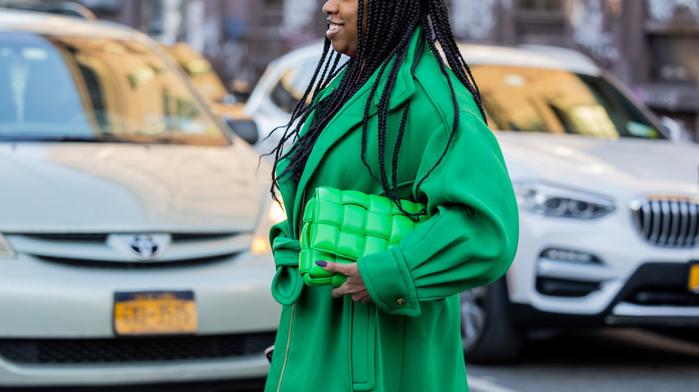 Girl wearing green trench coat 