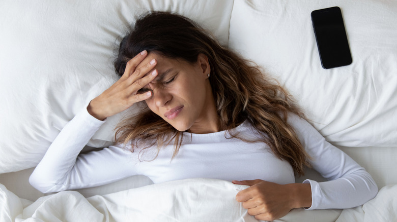 woman in bed with phone