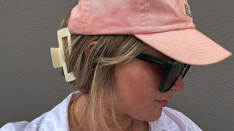 Woman wearing baseball cap with clip