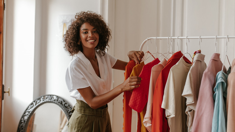 woman looking at rack of clothes