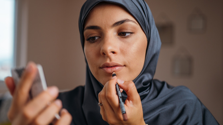 Woman using lip liner