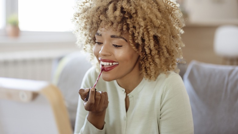 Woman applying lip makeup