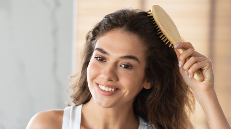 woman brushing her hair 