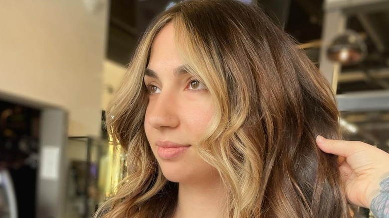 Woman with curled face framing hair