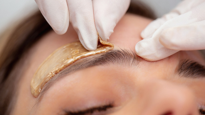 Woman getting an eyebrow wax