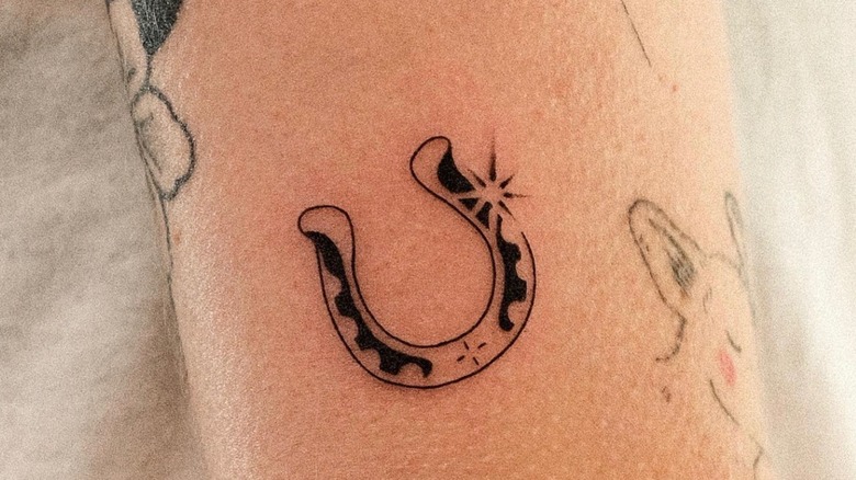 Black 3D Horseshoe With Rose And Banner Tattoo On Girl Foot