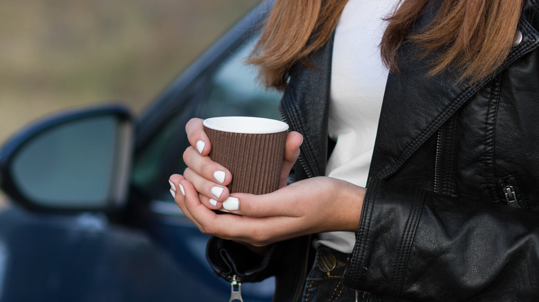 A woman showing her manicure