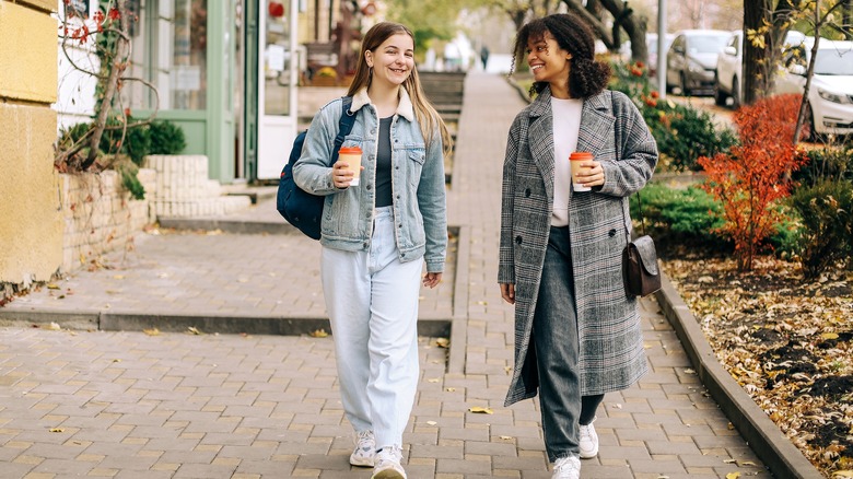 Female friends talking and walking