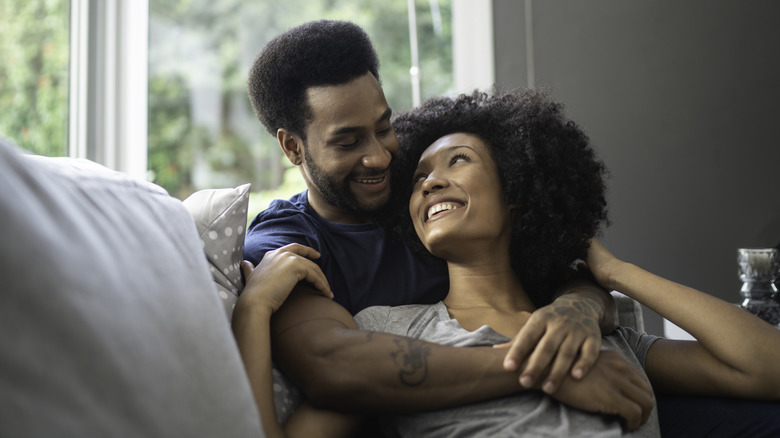 smiling couple on sofa