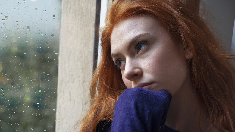 woman looking out window