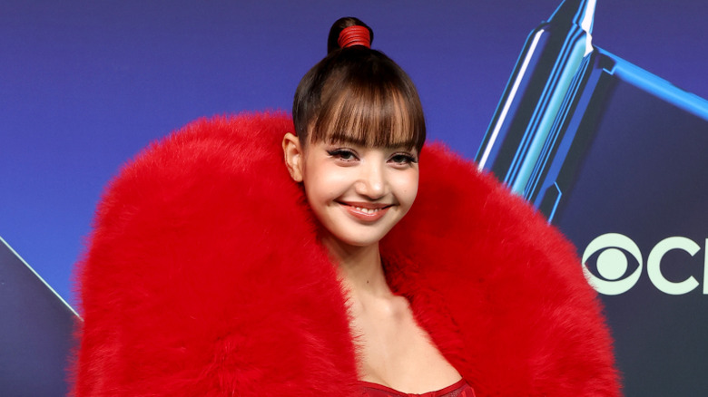 Lisa wearing a bad looking red ensemble at the 2026 MTV VMAs