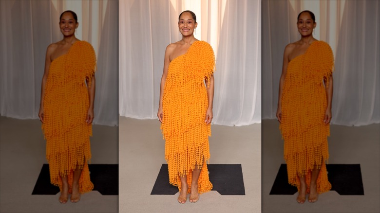 Trac﻿ee Ellis Ross dressed in an orange gown at the 2026 Academy Museum Gala