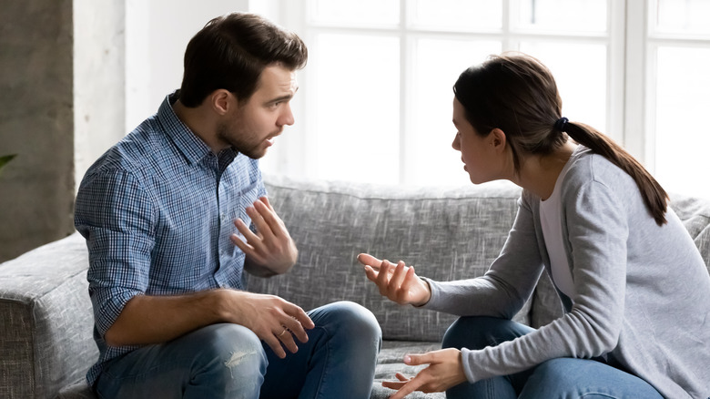 Couple arguing on couch