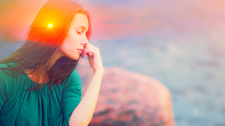 Woman in front of sunrise