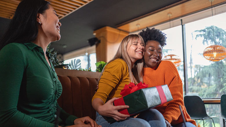 Three women exchanging gifts