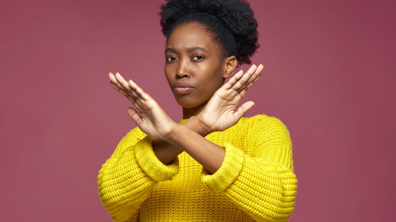 Woman crossing arms in negative gesture