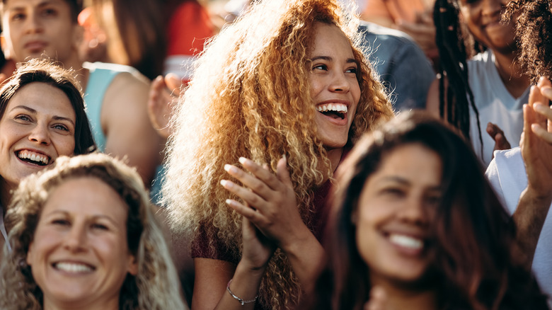 Woman clapping at a sporting event