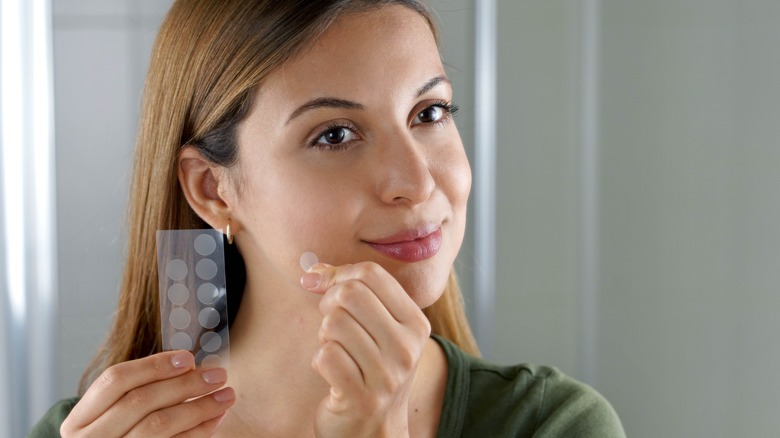 Woman wearing pimple patch