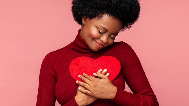 woman holding paper heart