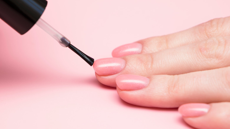 Applying pink polish 