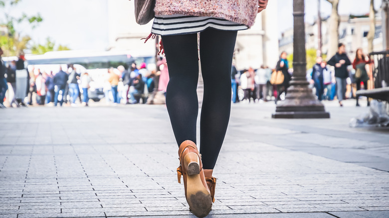 Woman wearing black leggings and ankle boots