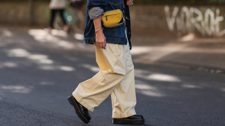 Woman wearing baggy trousers.