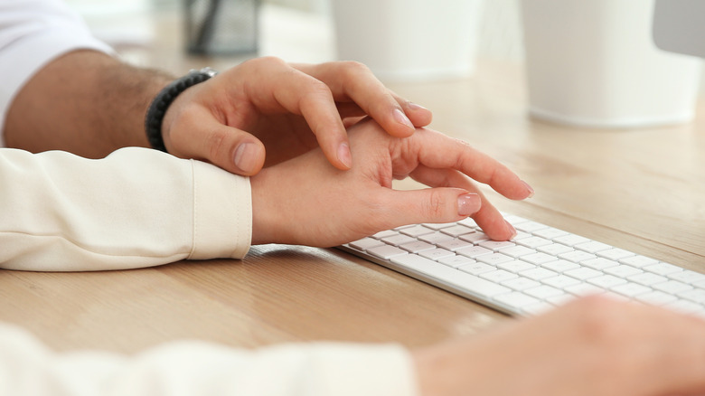 hands touching on keyboard