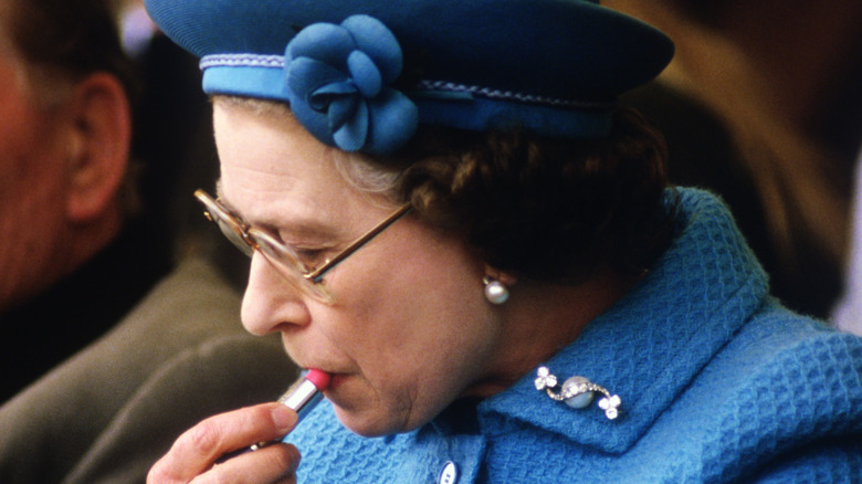 Late Queen Elizabeth II applying lipstick