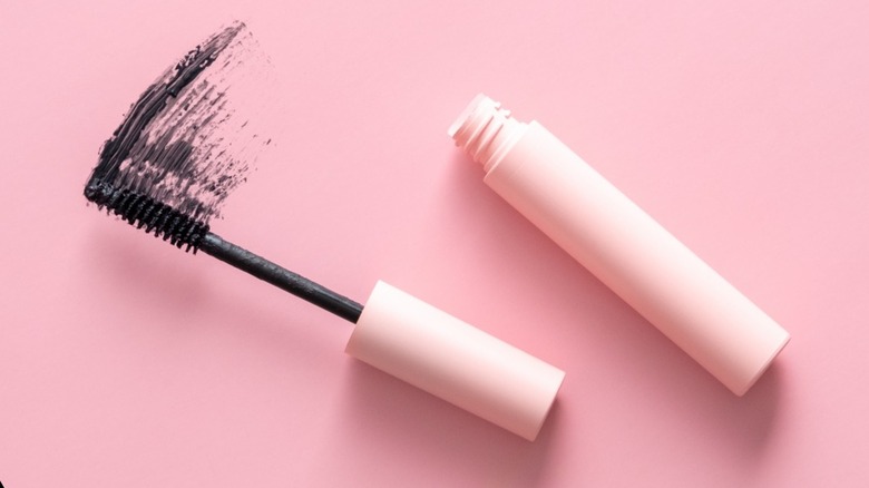 Open mascara on pink background