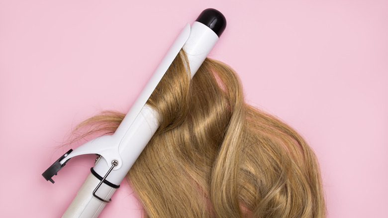 curling iron in blonde hair