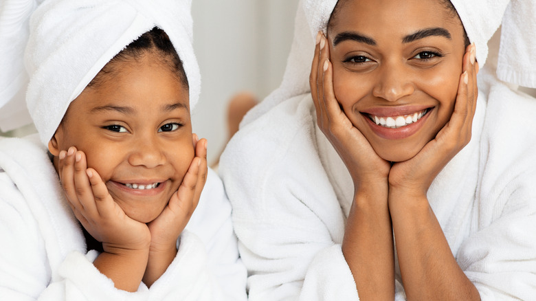 A woman with her child wrapped in towels